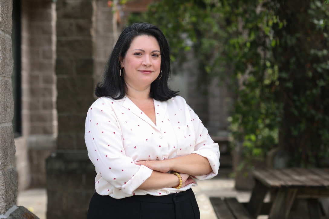 Itsa Ortiz, an advocate with Oregon Food Bank, stands confidently with her arms crossed, sharing her powerful story about overcoming the fear and stigma surrounding food assistance. She highlights the struggles immigrant families face in accessing food resources due to concerns about citizenship status and advocates for the right to food without fear or discrimination.