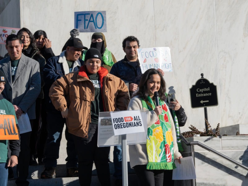 Andrea Williams speaks on the Oregon State Capitol steps, joined by advocates, delivering the 2025 State of Hunger Address and urging support for the Food for All Oregonians bill (SB 611).